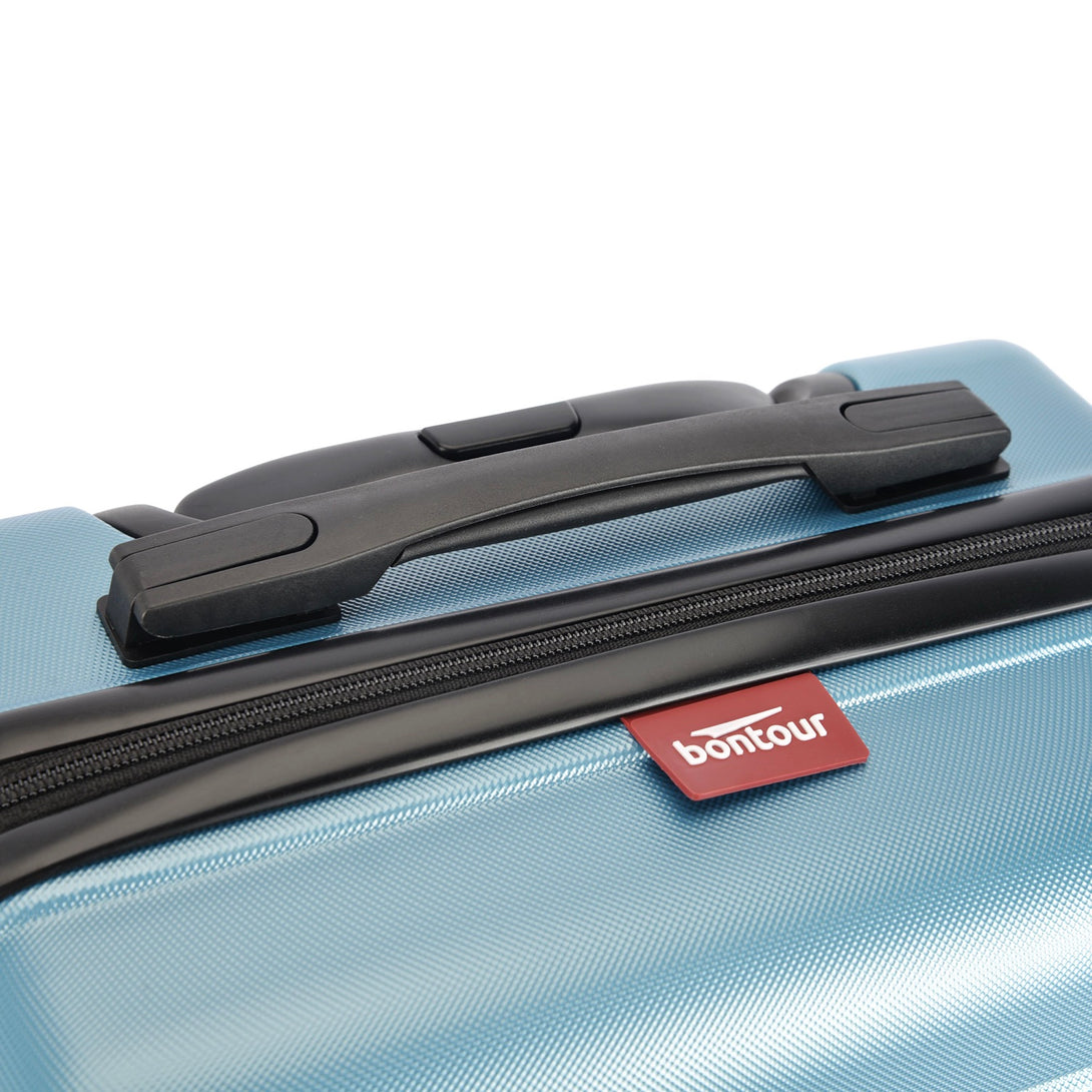 BONTOUR “spinner” közepes duplakerekes gurulós bőrönd, jégkék-VASBÚTOR