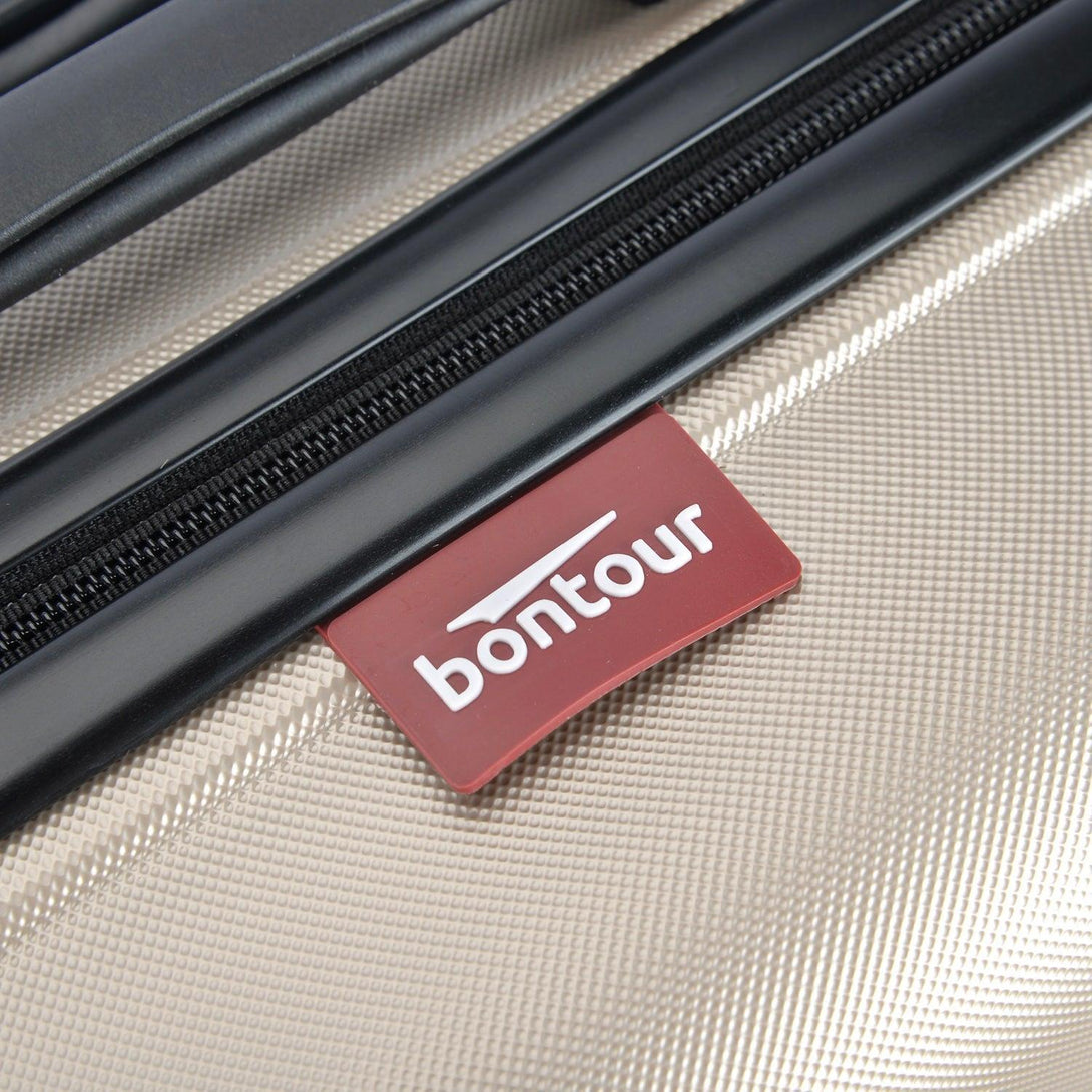 BONTOUR “spinner” közepes duplakerekes gurulós bőrönd, pezsgő-VASBÚTOR