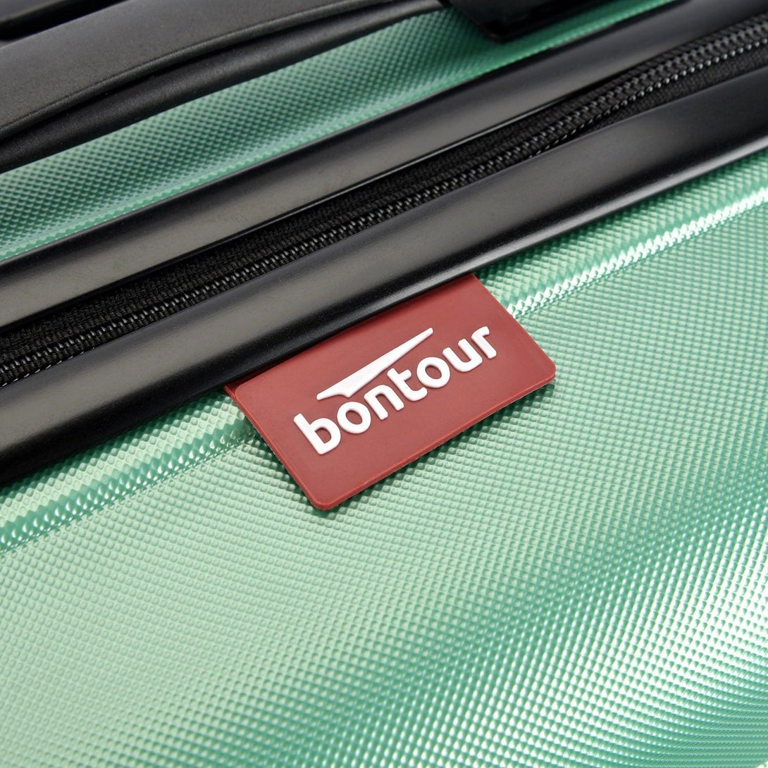 BONTOUR “spinner” közepes duplakerekes gurulós bőrönd, púderzöld-VASBÚTOR