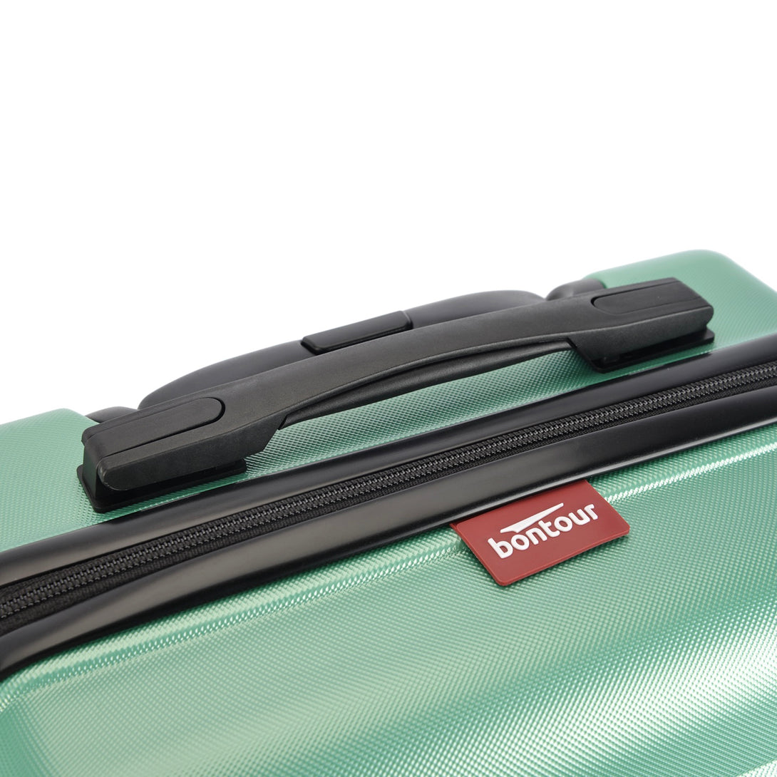 BONTOUR “spinner” közepes duplakerekes gurulós bőrönd, púderzöld-VASBÚTOR
